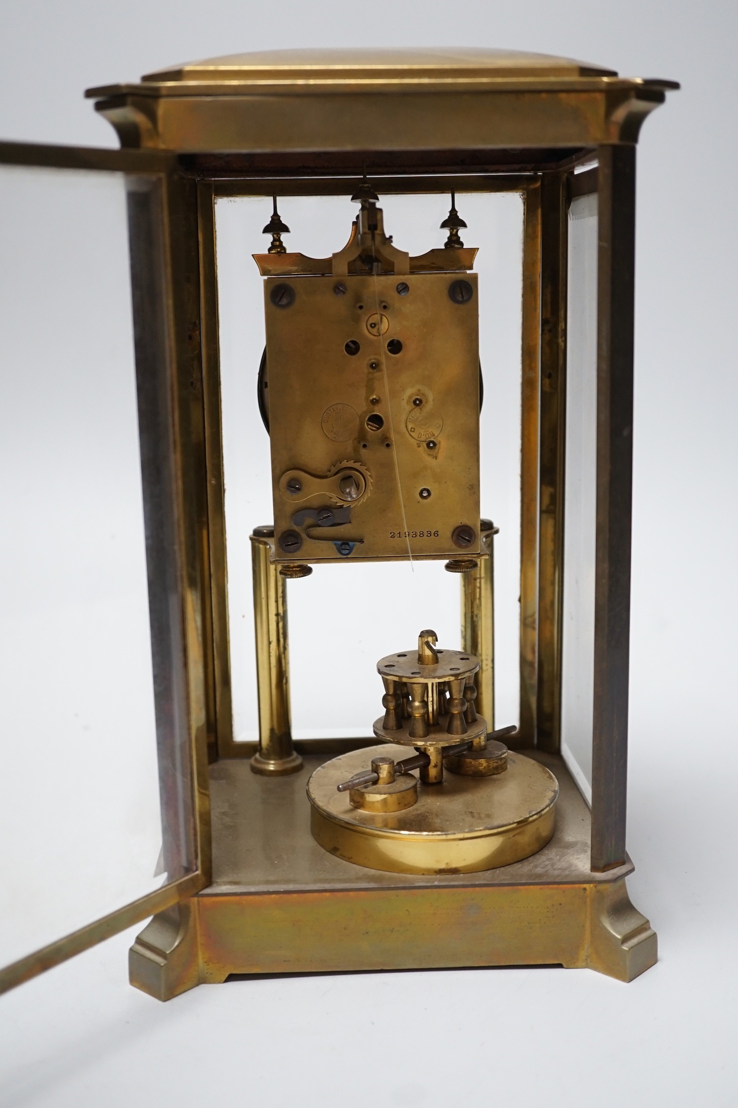 A brass four glass Anniversary clock, 29cms high